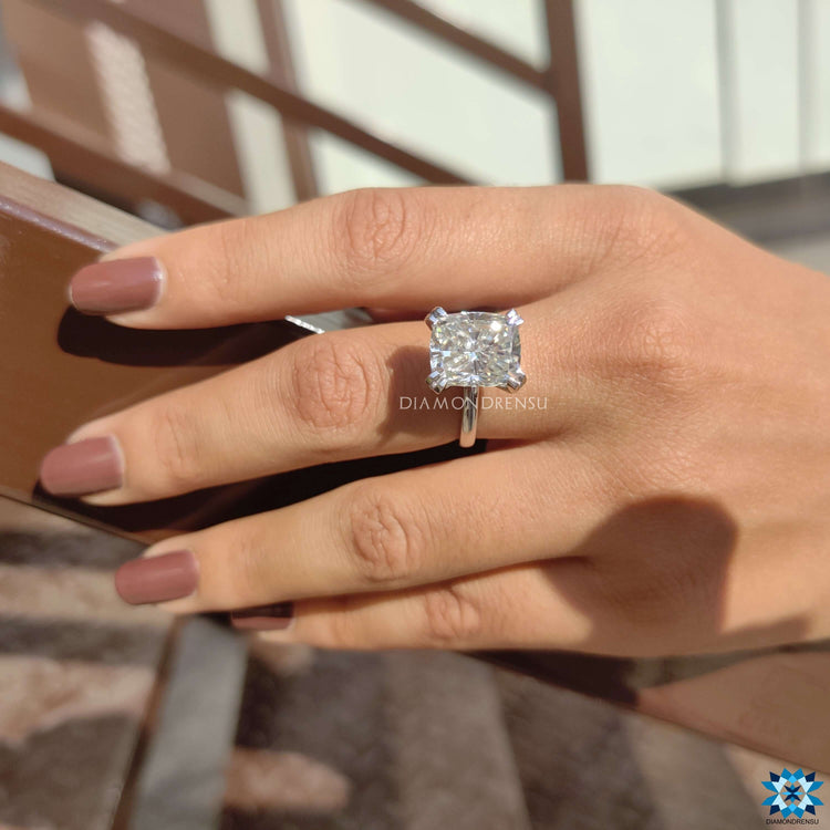 Elongated cushion solitaire featuring sparkling brilliance.