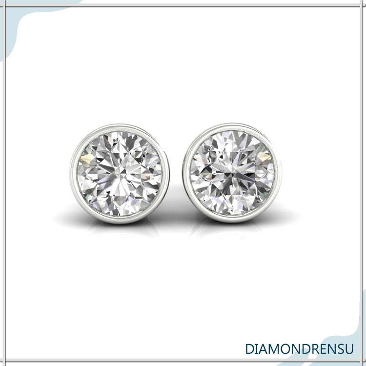 Brilliant round stud earrings with a sparkling diamond set in white gold.