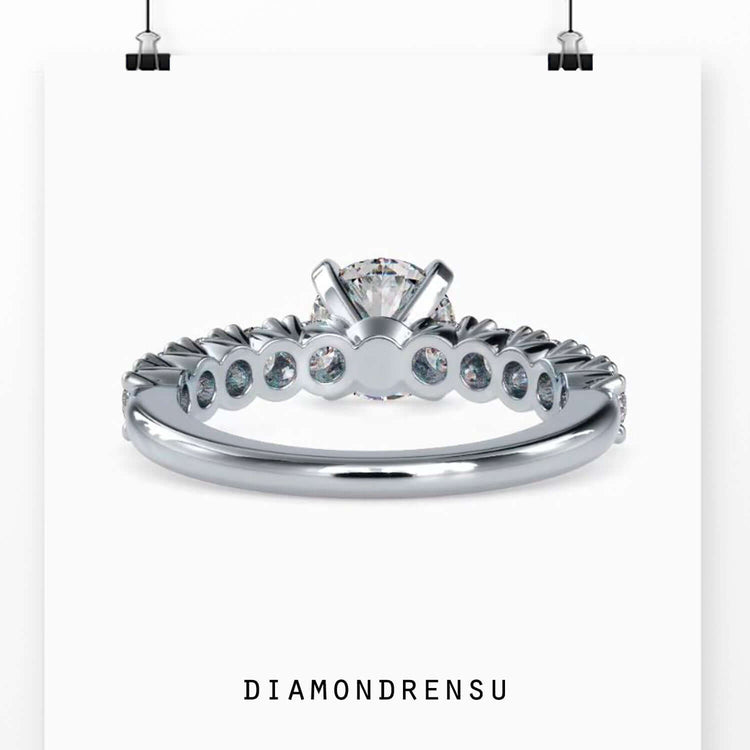 Classic round cut engagement ring featuring a gold pave band and brilliant cut diamond.