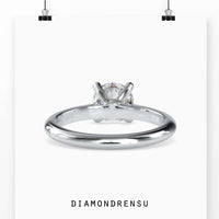 Round solitaire engagement ring with a rose gold band, perfect for the modern bride seeking understated luxury.