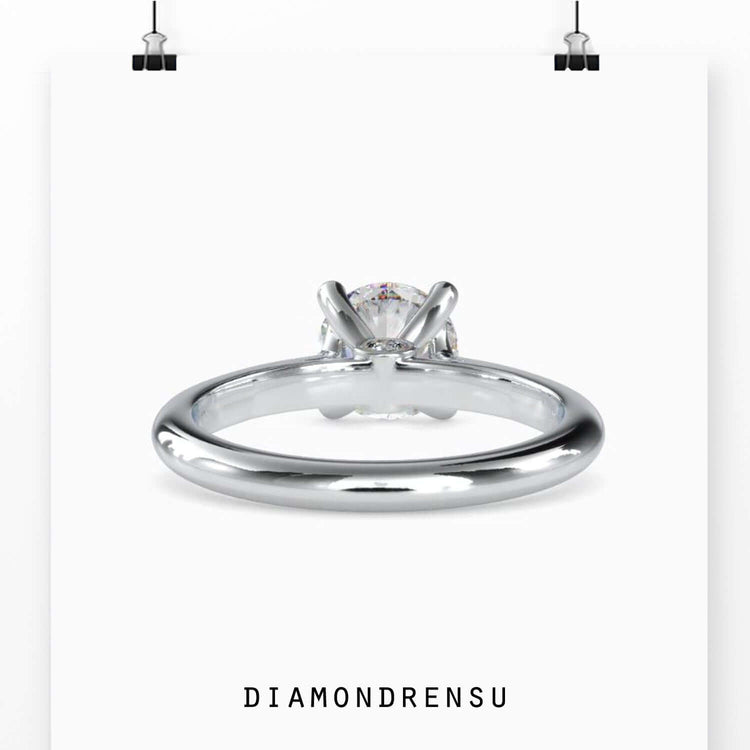 Round solitaire engagement ring with a rose gold band, perfect for the modern bride seeking understated luxury.