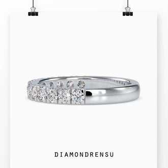 Round cut diamond wedding band with a French cut pavé set eternity band.