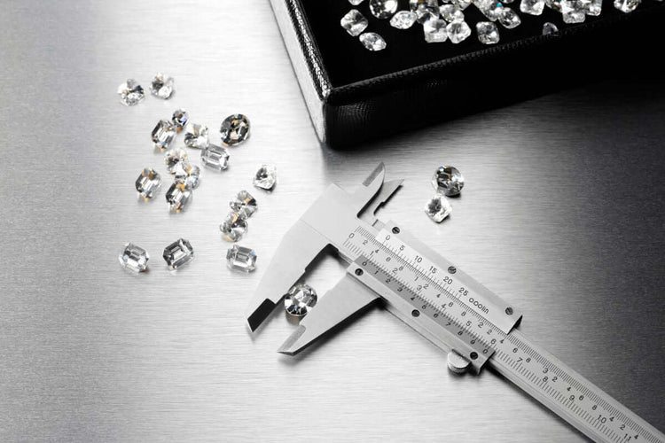 Measuring diamond with the help of caliper for ideal proportional purpose.