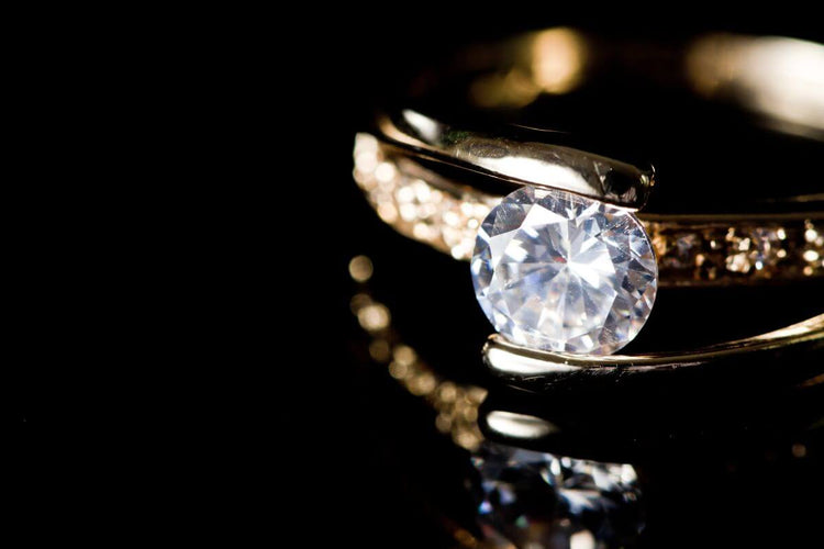 A beautiful old mine cut diamond ring with gold metal around it.