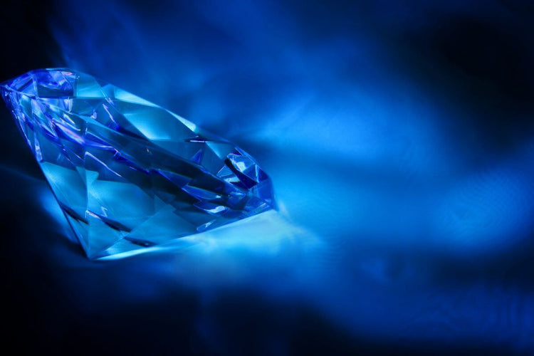 Beautiful Blue diamond ring kept on cushion.