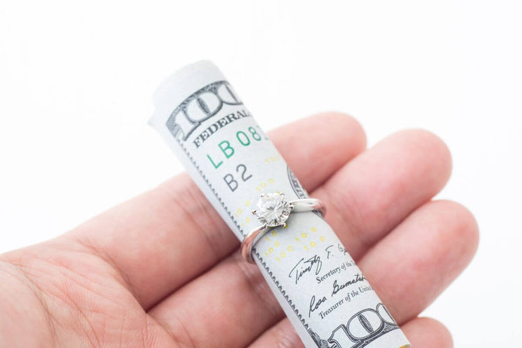 A ten thousand dollar bundle roled within the diamond ring.