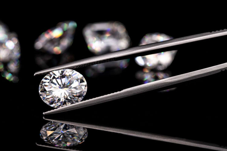 A diamond held in tweezers shows use for diamonds outside of jewelry