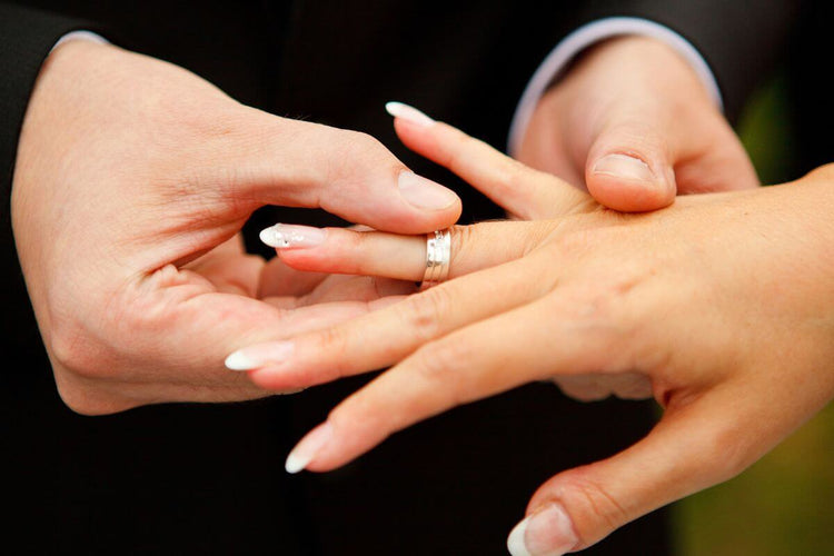 A woman wearing wedding ring in her right hand