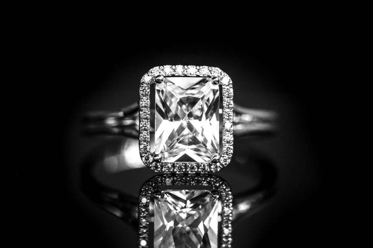 Moissanite diamond ring glowing under blacklight