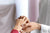 A woman with short finders wearing a diamond ring