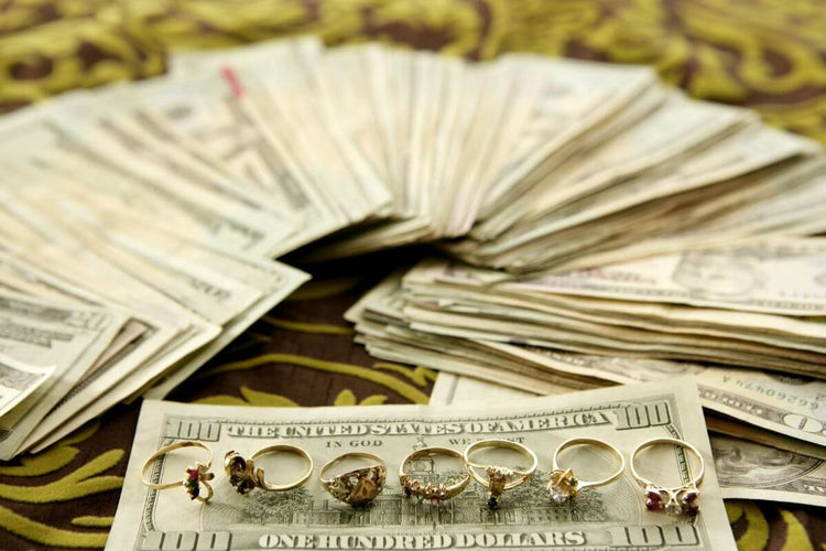 Different engagement ring kept on money showing their resale value is good.