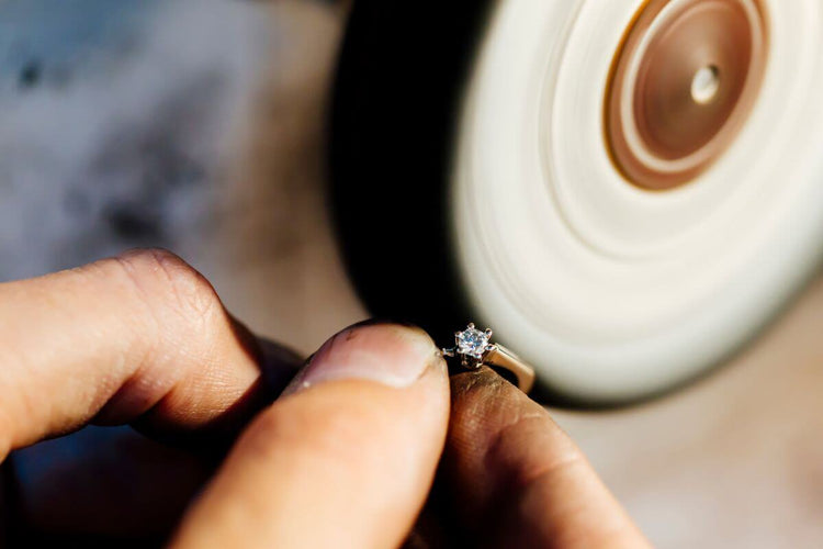A guy polishing a diamond ring