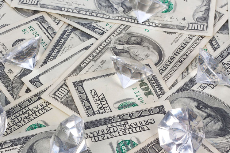 Various diamonds kept on money depicting their value 