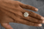 A beautiful round cut 9 carat diamond kept on the finger.