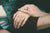 Two hands wearing promise rings