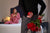 A man surprising his wife on valentine day with roses and a jewelry gift.