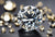 Moissanite with other diamonds on a table