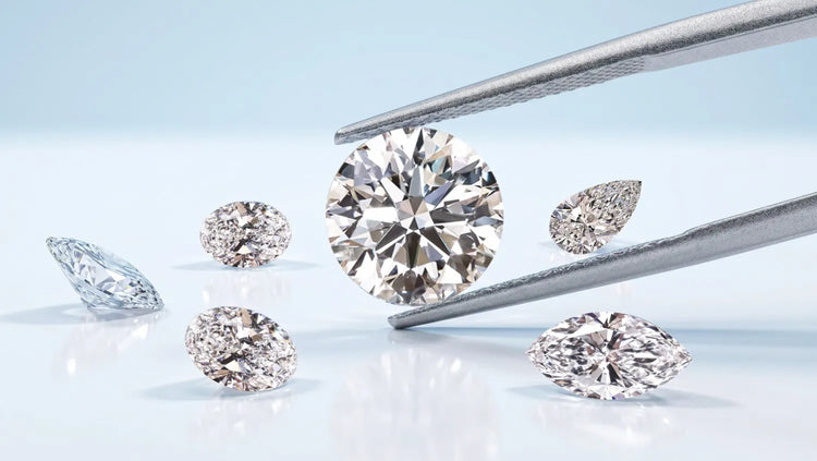 Collection of lab grown diamonds in various cuts displayed on a reflective surface, with a large round diamond held in tweezers, representing common myths about lab grown diamonds.