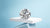 Polished Old European cut diamonds showcased on a white geometric pedestal with a clean light blue background.
