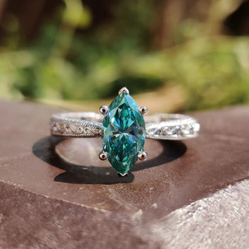 Marquise cut moissanite engagement ring with a handcrafted design.
