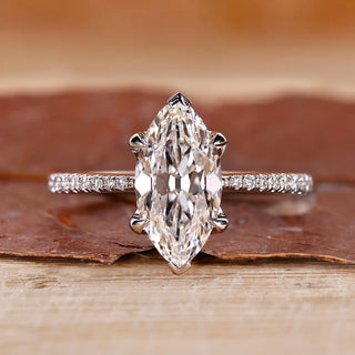 Marquise cut diamond ring with pave round cut band.
