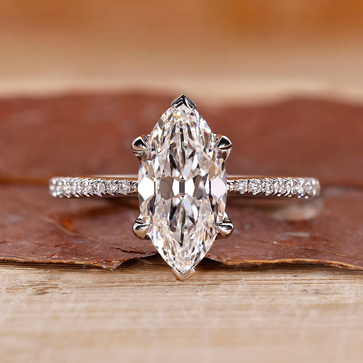 Marquise cut diamond ring with pave round cut band.
