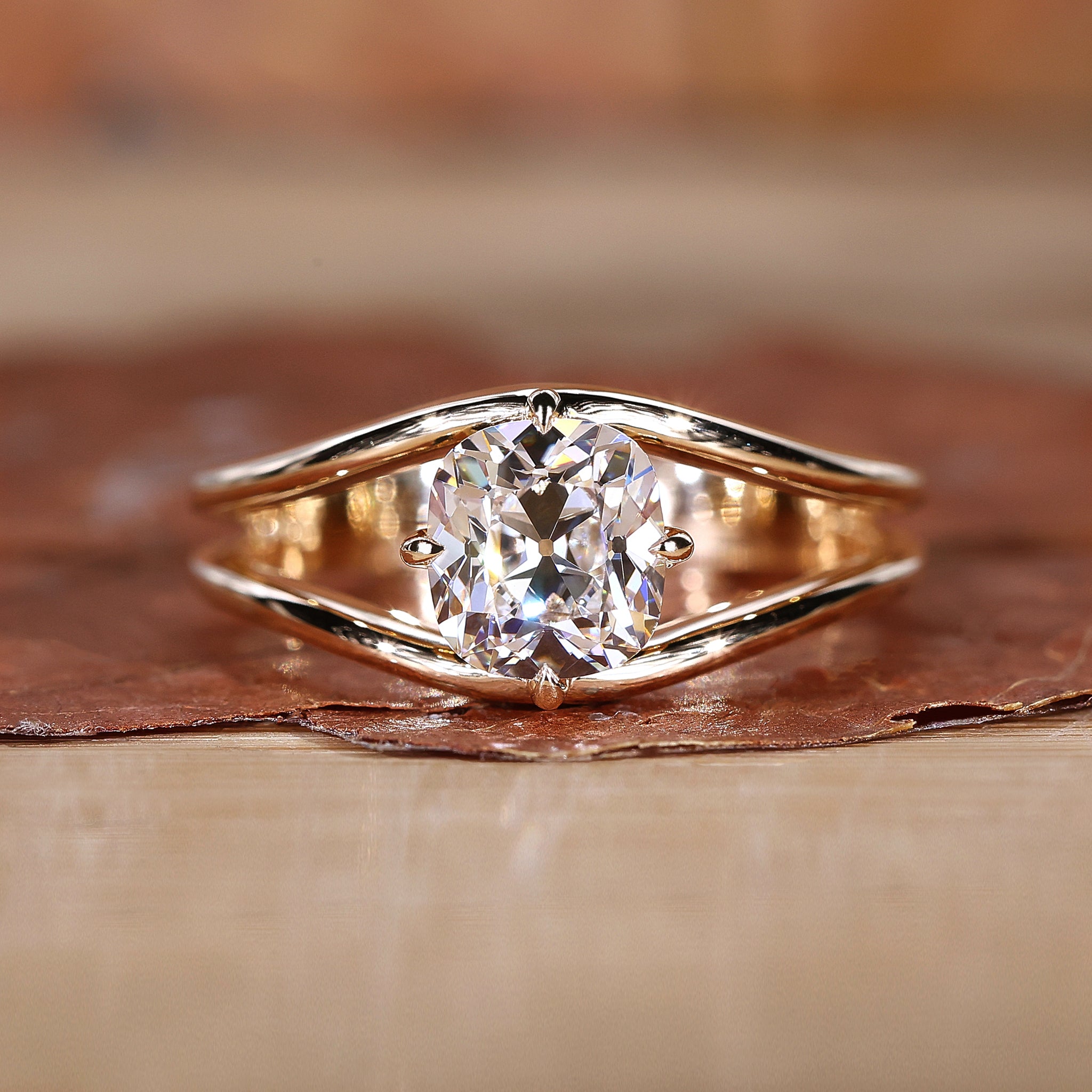 lose-up of a handmade old mine cushion cut diamond ring with intricate detailing.