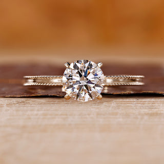 Yellow Gold Engagement Ring made with round cut diamond ring and four tab prong ring setting.
