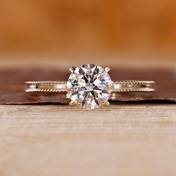 Yellow Gold Engagement Ring made with round cut diamond ring and four tab prong ring setting.
