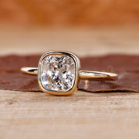 Cushion cut diamond ring in a bezel engagement ring for a contemporary look.
