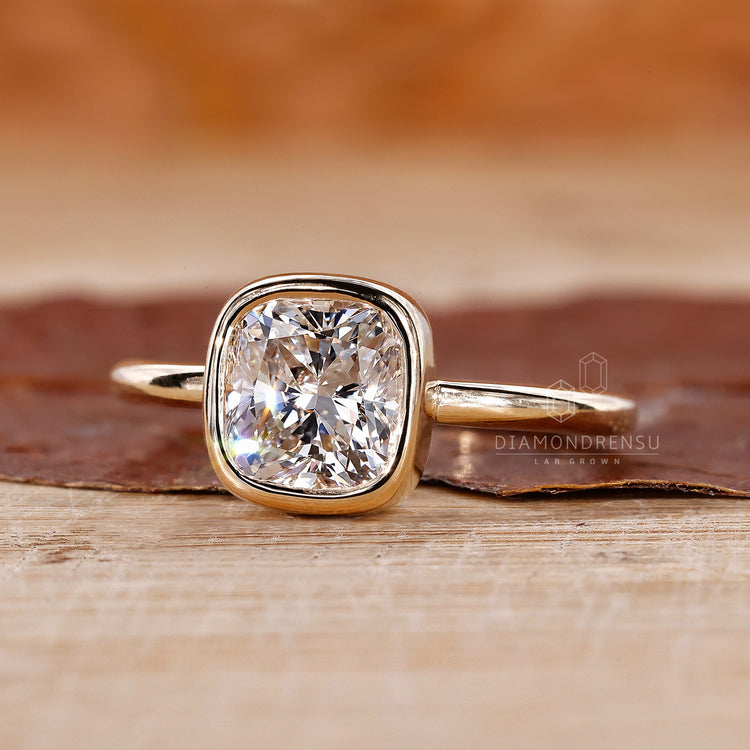 Cushion cut diamond ring in a bezel engagement ring for a contemporary look.
