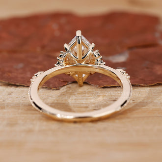 Custom diamond ring crafted in yellow gold with marquise cut center.
