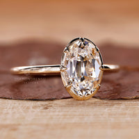 Claw prong setting solitaire engagement ring with oval old European cut diamond.
