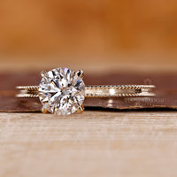 White gold ring styled in contrast to yellow gold engagement ring for variety.
