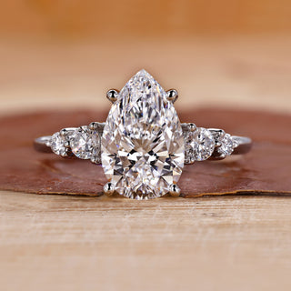 5 stone diamond ring with pear-cut center stone.
