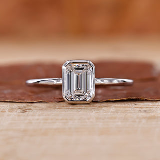 Solitaire Emerald Cut Ring featuring a stunning emerald cut diamond.