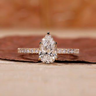 Pear shape diamond ring with a sparkling teardrop design and intricate details.
