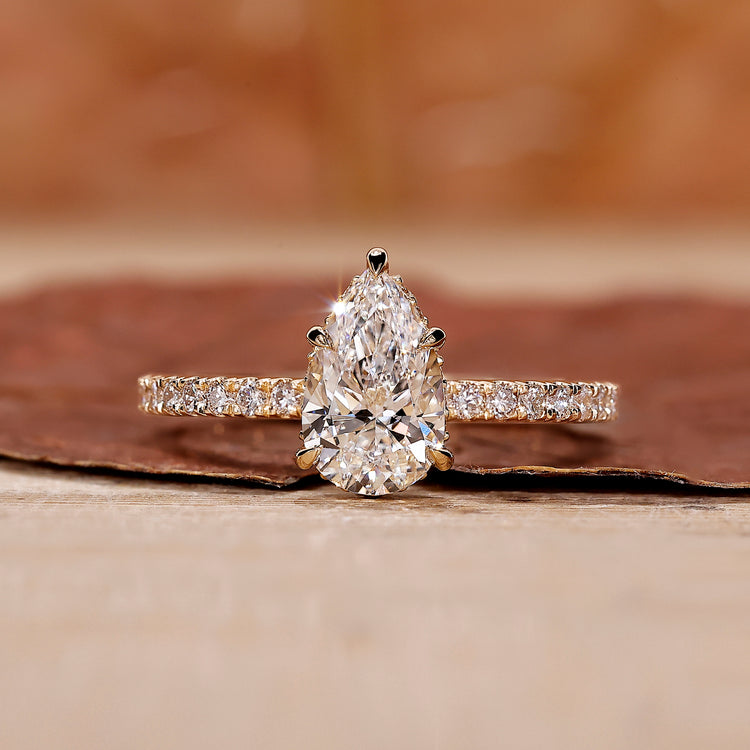 Pear shape diamond ring with a sparkling teardrop design and intricate details.
