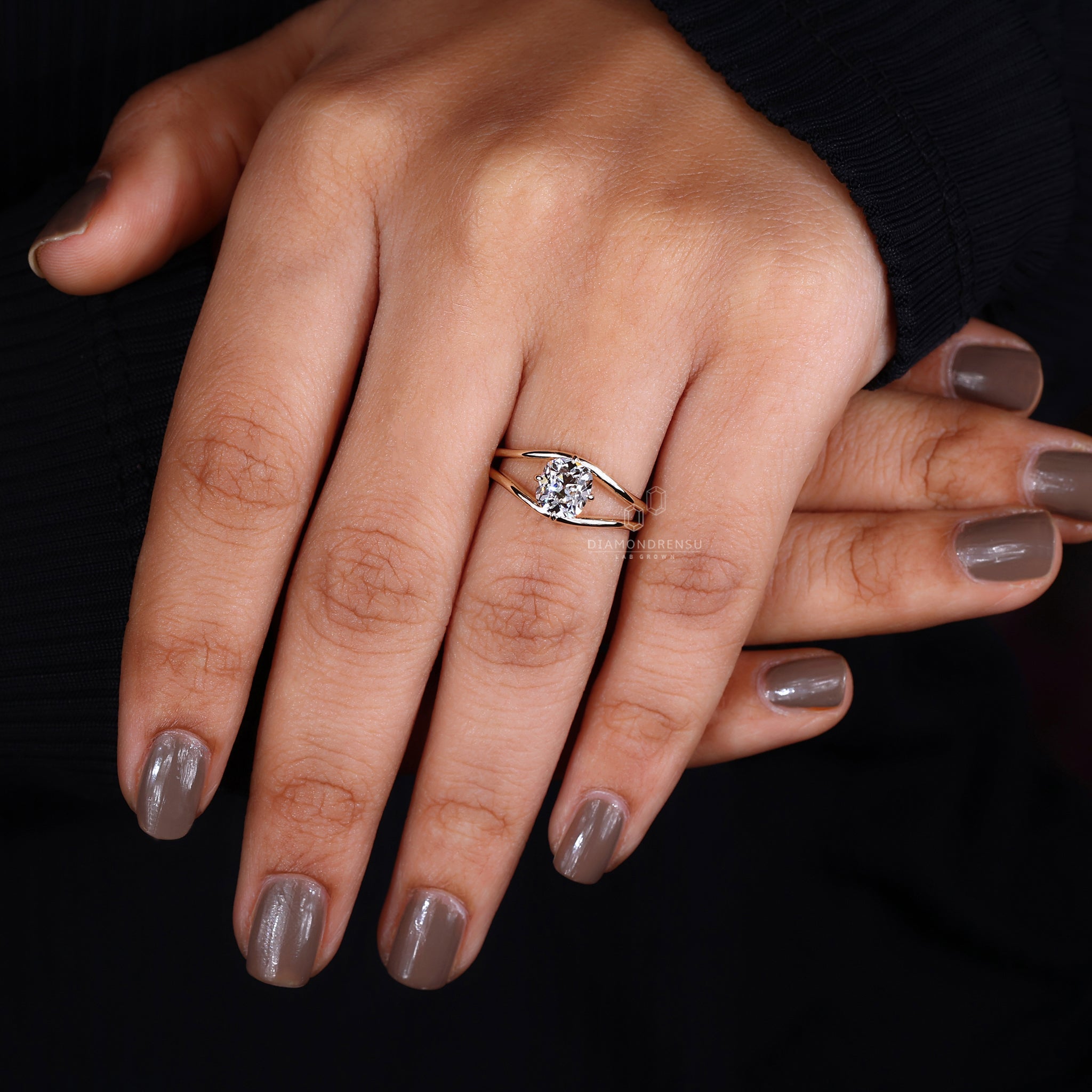 A model elegantly presenting a diamondrensu ring with an old mine cut diamond.