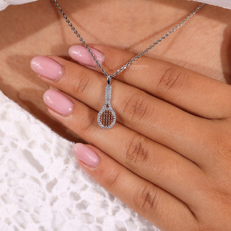 Handmade racket charm pendant with round diamonds in prong setting.
