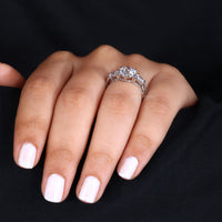 Three stone white gold ring with a sleek finish.
