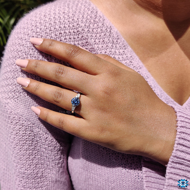 Dark blue moissanite ring with baguette side stones.