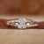 Elongated cushion cut engagement ring on hand, showcasing timeless elegance.