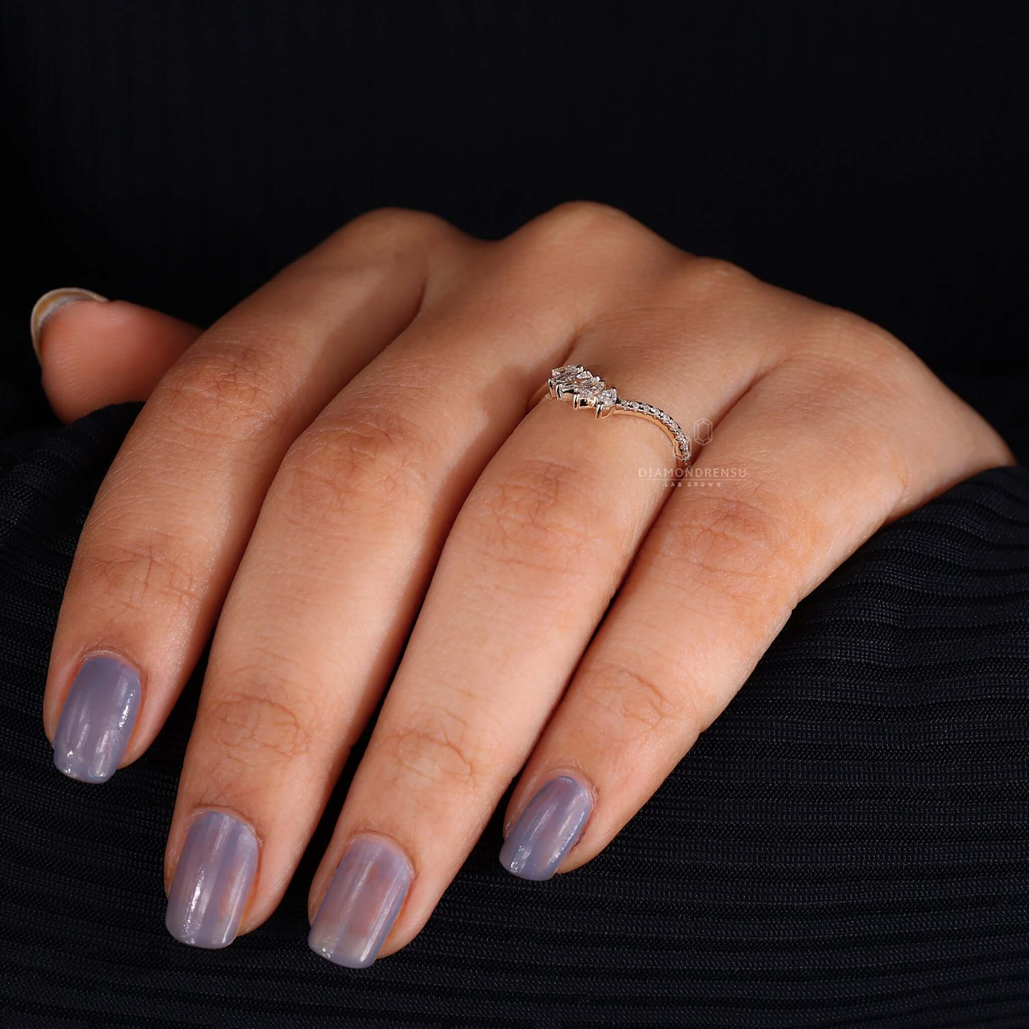 White gold diamond wedding band on a woman's hand, symbolizing love and commitment.