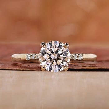 A stunning yellow gold engagement ring featuring a brilliant round diamond.
