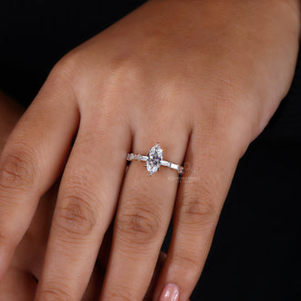 Baguette side stones adding elegance to a stunning marquise ring.
