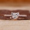 Heart shaped diamond ring in rose gold with pave setting design.
