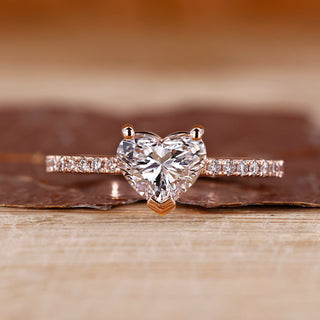 Heart shaped diamond ring in rose gold with pave setting design.
