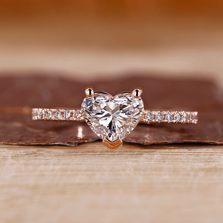 Heart shaped diamond ring in rose gold with pave setting design.
