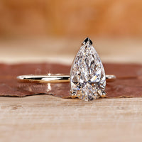 Prong setting engagement ring featuring a pear-shaped diamond for a secure fit.
